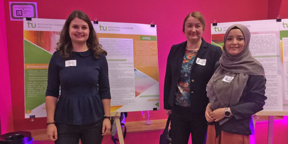 Group photo in front of the posters on the project