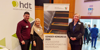 Group photo: Panourgias Papaioannou, Sude Pekşen, and Prof. Liudvika Leišytė stand next to a poster for the 2026 Gender Congress.