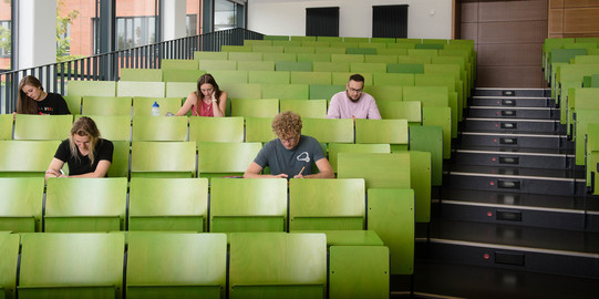 Archive of Lectures and Seminars Four students are sitting in a lecture hall.