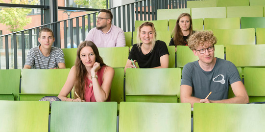 Lectures and Seminars A group of students are sitting in a lecture hall.